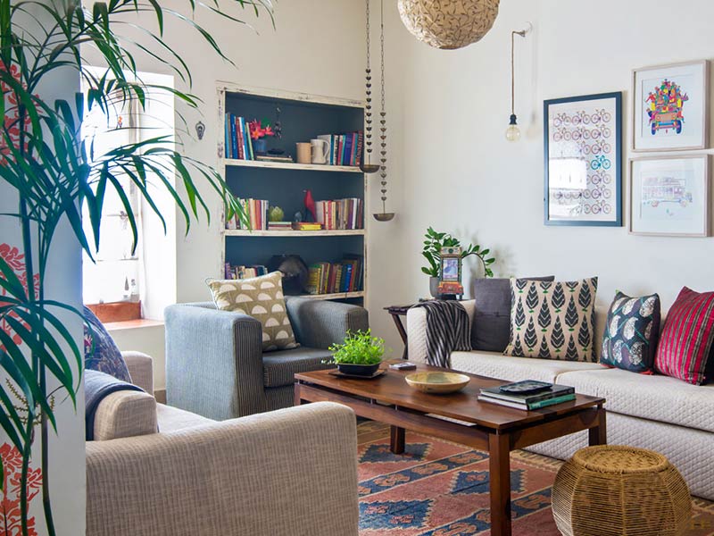 Indian style living room with sofa & wall art - Beautiful Homes